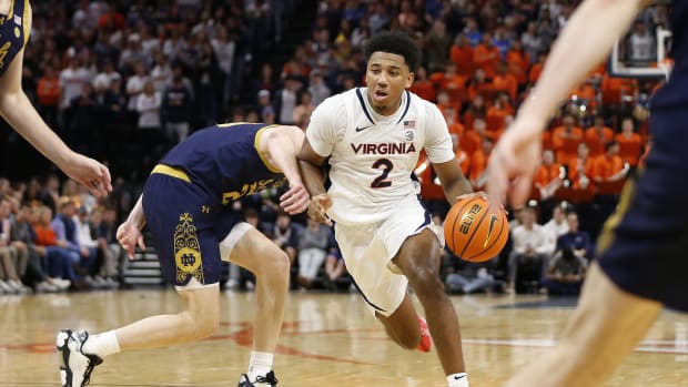 Virginia Cavaliers guard Reece Beekman (2) dribbles the ball past Notre Dame Fighting Irish guard J.R. Konieczny (20) during the second half at John Paul Jones Arena.